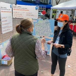 Photo of an SFMTA staffer talking to a customer