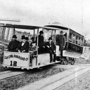 Photo of original cable car in late 1800s with male passengers on board