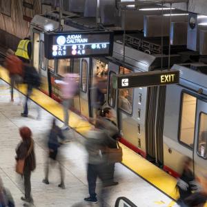 Blurred image of people loading on to train at Embarcadero Station