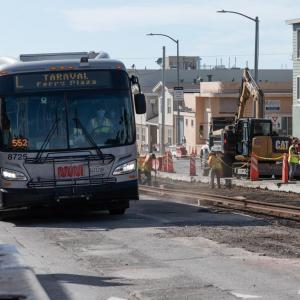 L Taravel bus passes construction of rails on Taraval Street