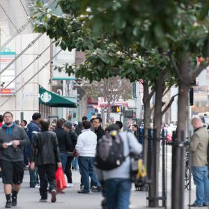 People walking along a busy sidewalk in SOMA