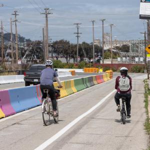 New protected bike lane on Hunters Point Blvd in the Bayview, concrete (mural) barriers designed by local artists 