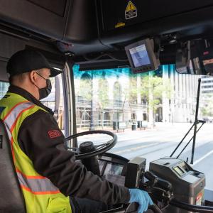 Photo of a bus operator wearing a mask