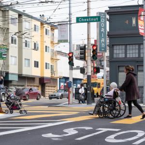 Woman pushes woman in wheelchair on Chestnut Street