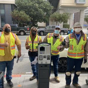 Parking meter shop crew installing the new pay-by-license-plate paystation system on 4th Street at UCSF Mission Bay Campus 