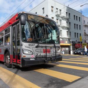 Photo showing an 8AX Bayshore Express articulated Muni bus on the road