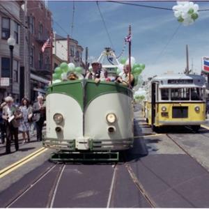 Photo of the Boat Tram on parade at the 1983 Trolley Festival with parade goers waving in excitement.