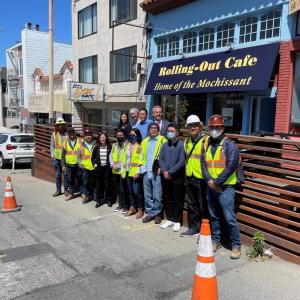 Photo depicting Directors, Supervisor, Staff and Crew outside a cafe on Taraval St on a Shared Space parklet 