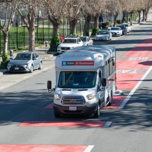 SFMTA Paratransit bus traveling in a transit lane. 