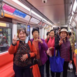 Image of Muni Metro riders smiling at the camera