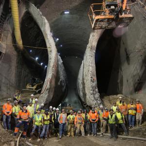 Construction and crew underground in a front of two boring entrances 