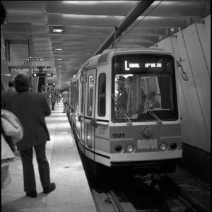 black adn whtie photo of Muni LRV signed for L Taraval Line at platform in Embarcadero Station