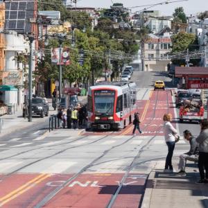 J Church using red transit lanes and picking up passengers on a boarding island on Church at Market Street. 