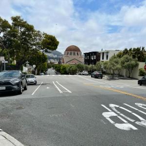 Street view of Arguello Boulevard with cars parked on either side.