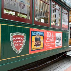 A cable car with banners for Market Street Railway Co. and 150 years of the Cable Cars.