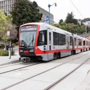 N Judah train on the street.