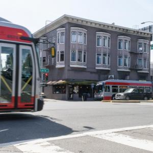 Two buses traveling on Geary Boulevard in the Richmond