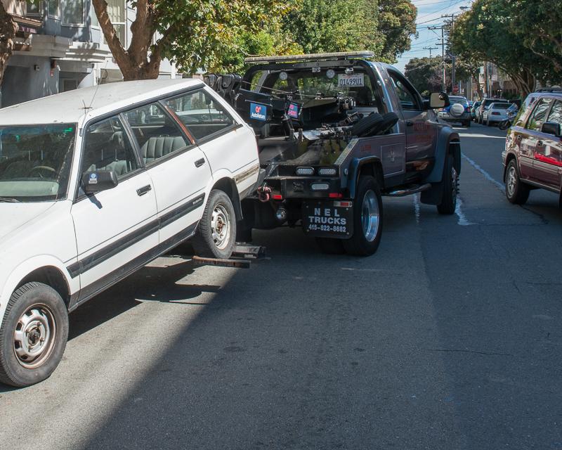 car being towed by tow truck