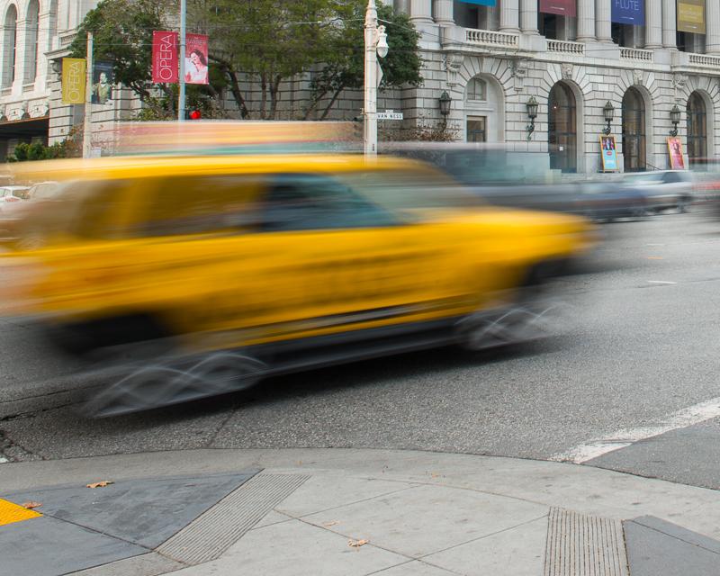 blurred motion photo of taxi driving on van ness