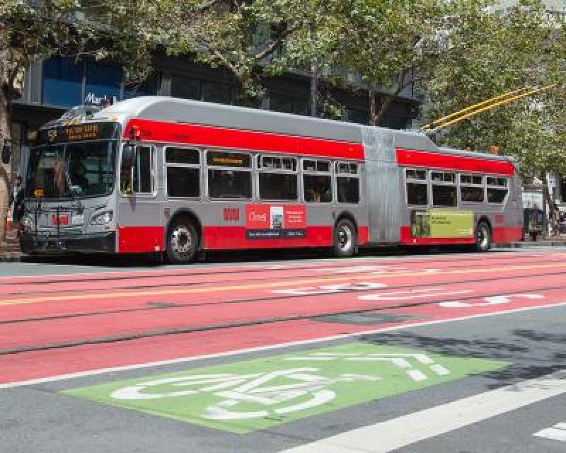 Front 3/4 view of new Muni trolley bus on street.