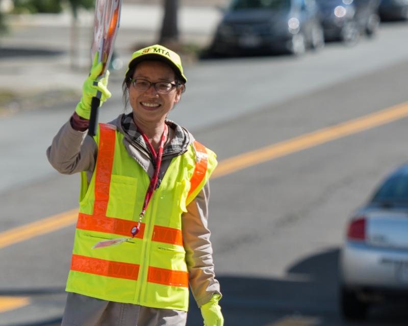 a crossing guard stands at an intersection
