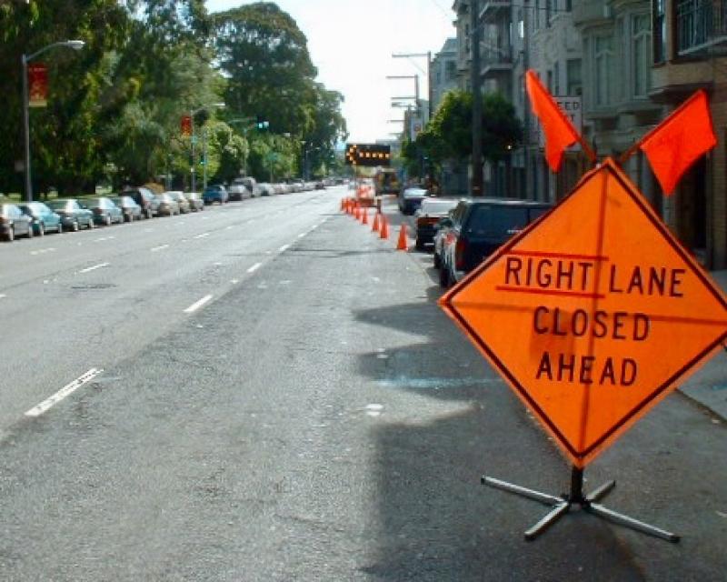 construction work with right lane closed ahead signage